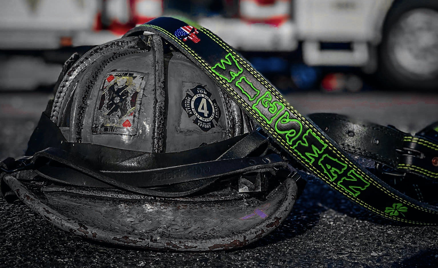 Weathered fire helmet with custom JP radio strap
