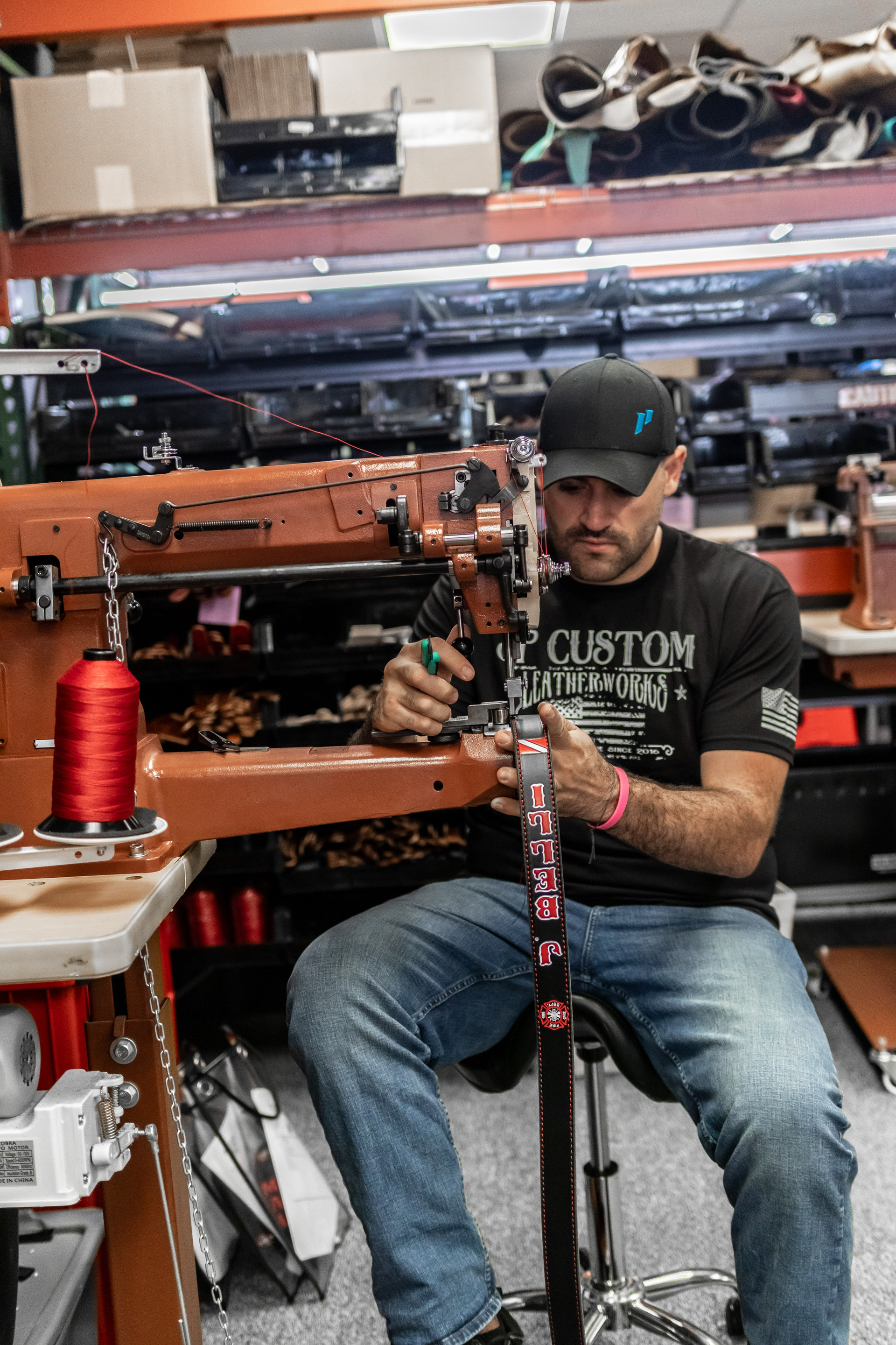 Joe Petito stitching a custom strap on the leather machine